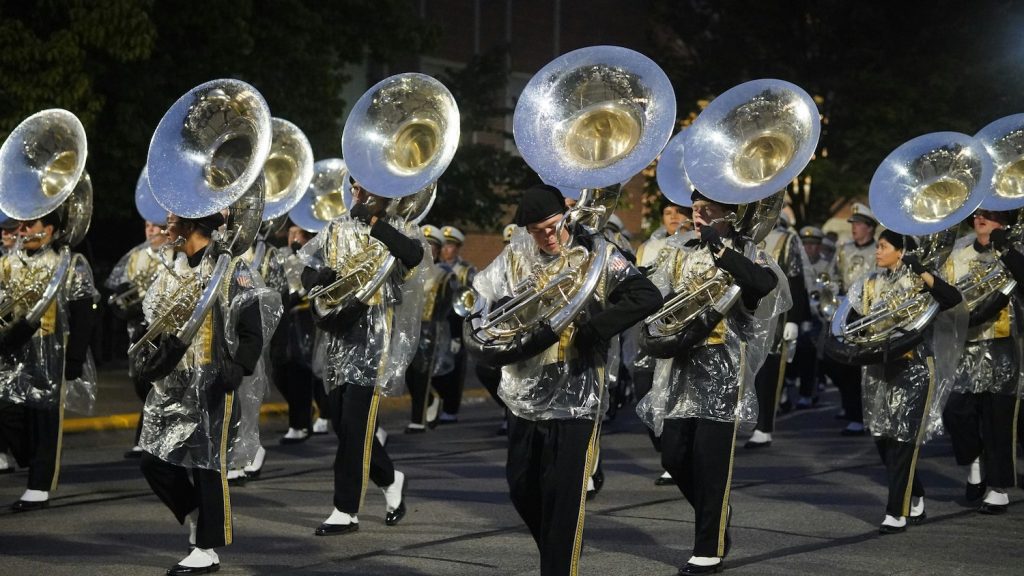 musicians playing sousaphone's marching down the street